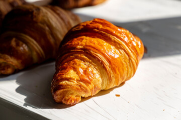 Freshly baked crispy delicious croissant on the table 