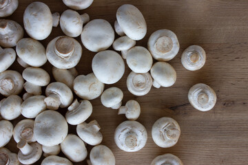 White champignons, fresh mushrooms on the table.