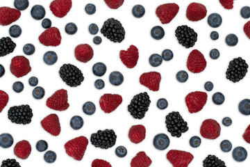 Berries pattern isolated on white. Strawberries, raspberries blackberries and blueberries arranged on white. Top view.