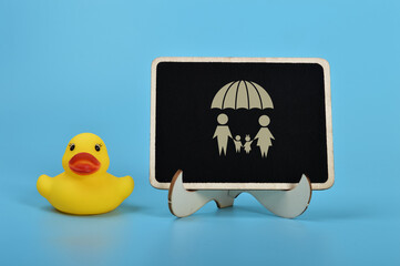 Toy duck and family insurance symbol. Protecting family Insurance concept