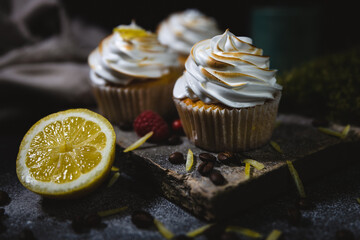chocolate cupcake with icing on a wood board