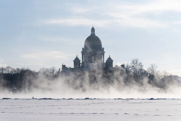 Saint Isaac's Cathedral in Saint-Petersburg, Russia. In winter, backlit and through a mist over Neva river