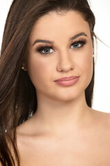 Obraz premium Beautiful female model with brown straight long hair and daytime makeup.