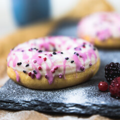 donut with sprinkles and icing pink and white