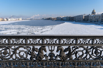 Fence of the Annunciation Bridge (Blagoveshchensky, or Lieutenant Schmidt Bridge) is covered with snow. Saint-Petersburg, Russia
