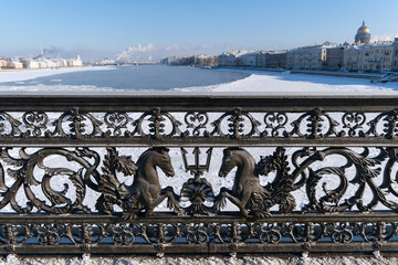 Fence of the Annunciation Bridge (Blagoveshchensky, or Lieutenant Schmidt Bridge) is covered with snow. Saint-Petersburg, Russia