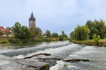 Rapids river Werra and Church historical city Bad Sooden-Allendorf in Hessen, Germany