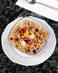 Traditional Dessert Asure, Noah's Pudding. Traditional Turkish dessert Asure or Ashura from boiled cereals with dried fruits and pomegranate grains.