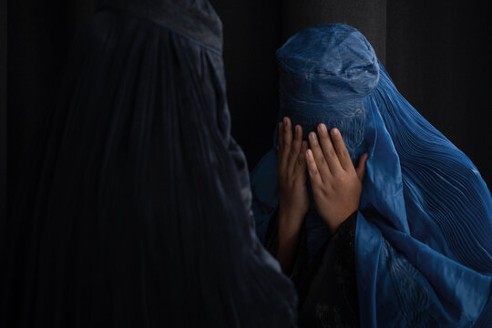 Muslim woman in Burka or Burqa, tradition cloths in Afghanistan and west Pakistan greeting to each other, Salam, As-salamu alaykum, Peace be upon you, black background