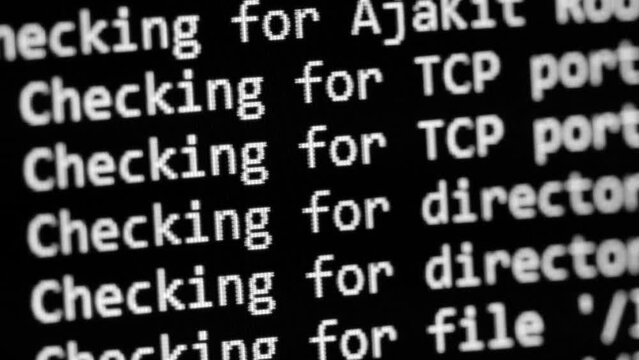 Computer code. Check and scan for possible computer threats and cybercrime. Network and file integrity check. Textual log information scrolls across the black screen