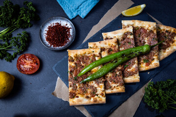 Turkish pide pastry baked in a stone oven served on stone plate with minced meat