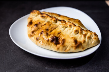 Italian calzone on a white plate