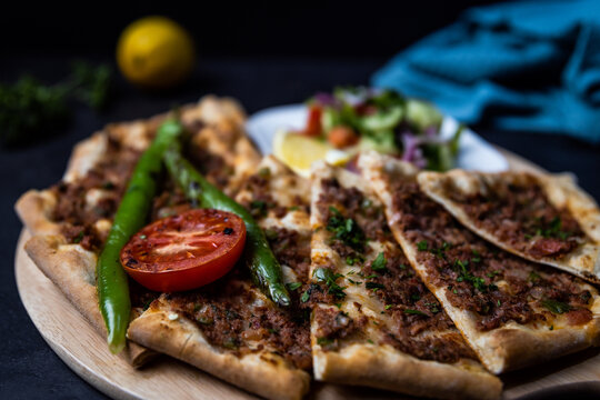 Turkish pide pastry baked in a stone oven served on stone plate with minced meat