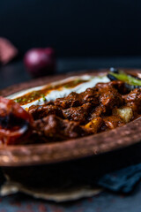 turkish iskender kebab closeup on copper plate