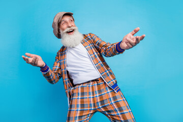 Photo of funky positive pensioner wear checkered trendy suit look empty space enjoy comedy concert...