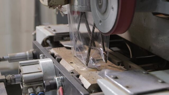 Automatic filling of plastic bags with ready-made tea on the conveyor of a modern tea factory.