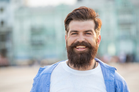 happy bearded man walk outside. face of man with beard. brutal casual man outdoor