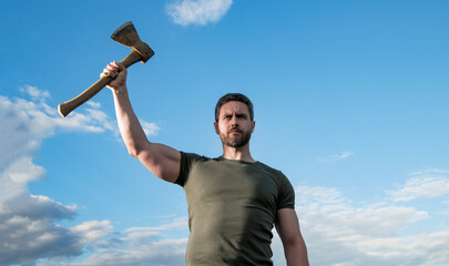 confident man with axe. caucasian man hold ax. brutal man showing strength on sky background