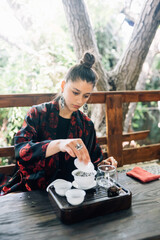 Process brewing tea. Woman steeping herbal tea