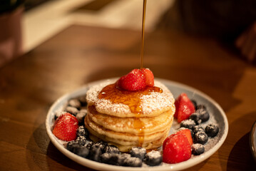 pancakes with berries and syrup