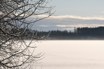 Beautiful and peaceful scenery at snowy frozen lake in Finland