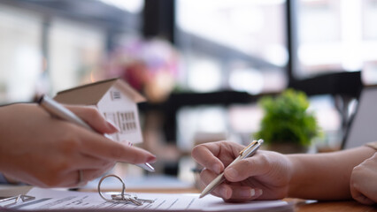 Real estate agent offer hand for customer sign agreement contract signature for buy or sell house....