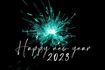 Happy new year 2023 turquoise sparkler new years eve countdown. Luxury entertainment celebration turn of the year party time. Premium nightlife visual with glowing light sparks on dark background - 556134907