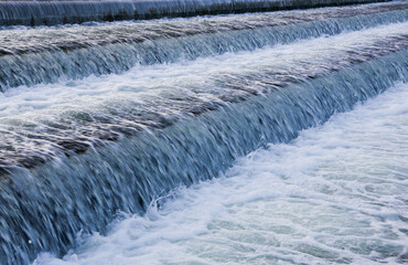 A close-up of a waterfall descending from a lake.