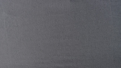 Abstract background of stretched gray natural fabric.