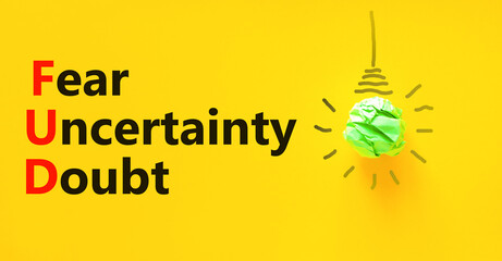 FUD fear uncertainty doubt symbol. Concept words FUD fear uncertainty doubt on yellow paper on a...