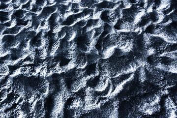 Black sand with snow
