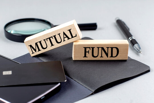 MUTUAL FUND text on wooden block on black notebook , business concept