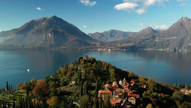 Scenic aerial view of Vezio Castle, above the Varenna town, at the center of Lake Como in northern Italy. Vezio castle is an ancient military outpost of early medieval origin