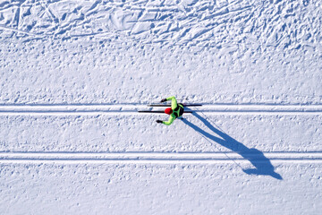 Winter sports competitions, cross country skis glide on fresh snow, aerial top view - obrazy, fototapety, plakaty