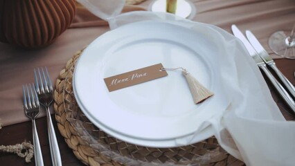  Close-up beautiful plates on the table. Beautiful wedding decor, all decorated in boho style, camera moving slow motion.