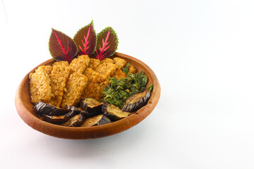 Mendoan or fried tempeh. fried soybeans. cholesterol foods. Combine fried eggplant and green...