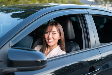 Fototapeta na wymiar Young asian beautiful woman driving a car with fastened seatbelt