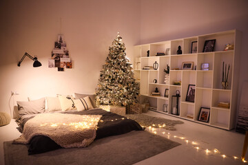 The room is decorated in a New Year's style with a Christmas tree and toys