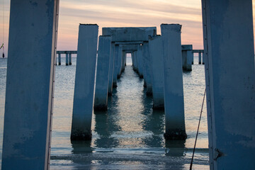 Dock Pilings of Fort Myers Beach fishing pier after Hurricane Ian