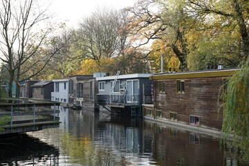 Canal in the country with floating houses in Delft, Netherlands 