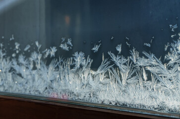 White Winter Frost on Freezing Cold Glass Window Pane