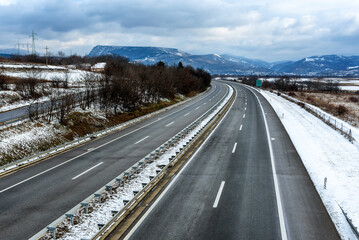 
Silent freeway road in snowy winter season. Asphalt highway background. Winter Landscape with snowy fields