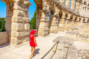 Tourist girl walking inside Pula Amphitheater or Coliseum of Pula is a well-preserved Roman...