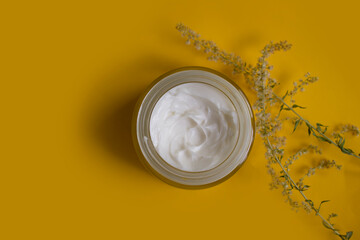 Cream cosmetic flower on colored background