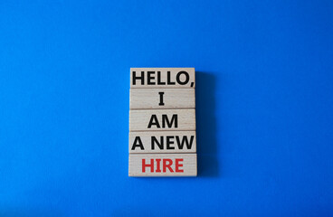 Hello I am a new hire symbol. Concept words Hello I am a new hire on wooden blocks. Beautiful blue background. Business and Hello I am a new hire concept. Copy space.