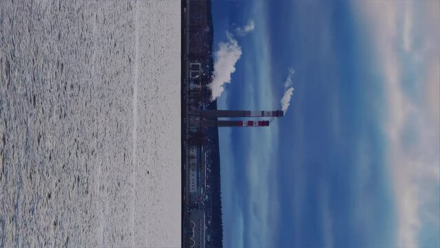 View of the tall chimneys of an industrial enterprise with a chimney polluting the atmosphere. The plant for the production of strategic intercontinental missiles "Topol-M". Russia, Votkinsk 2022