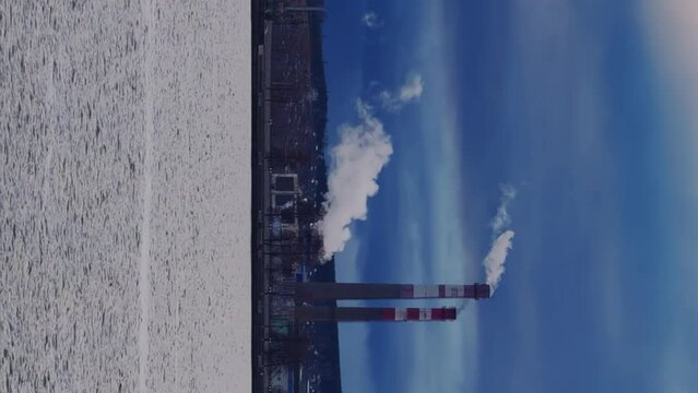 View of the tall chimneys of an industrial enterprise with a chimney polluting the atmosphere. The plant for the production of strategic intercontinental missiles "Topol-M". Russia, Votkinsk 2022
