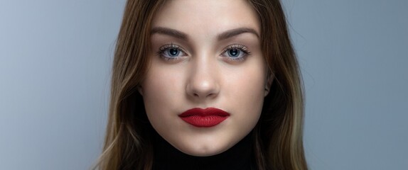 Fototapeta premium Portrait of a young, alluring, blonde girl with red lipstick. Banner, wide