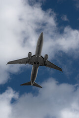 Air Force plane on a inferior view with a blue sky and clouds