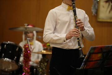 Fototapeta premium A person playing clarinet in an orchestra at a Christmas concert